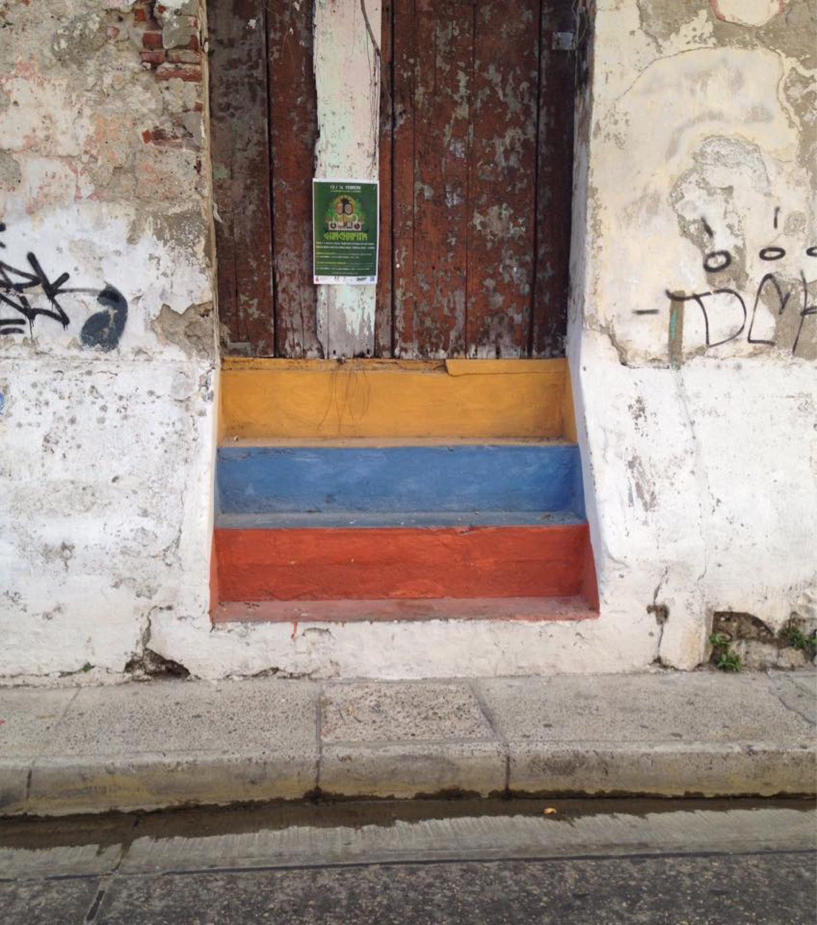 Colourful steps and a weathered doorway in Colombia